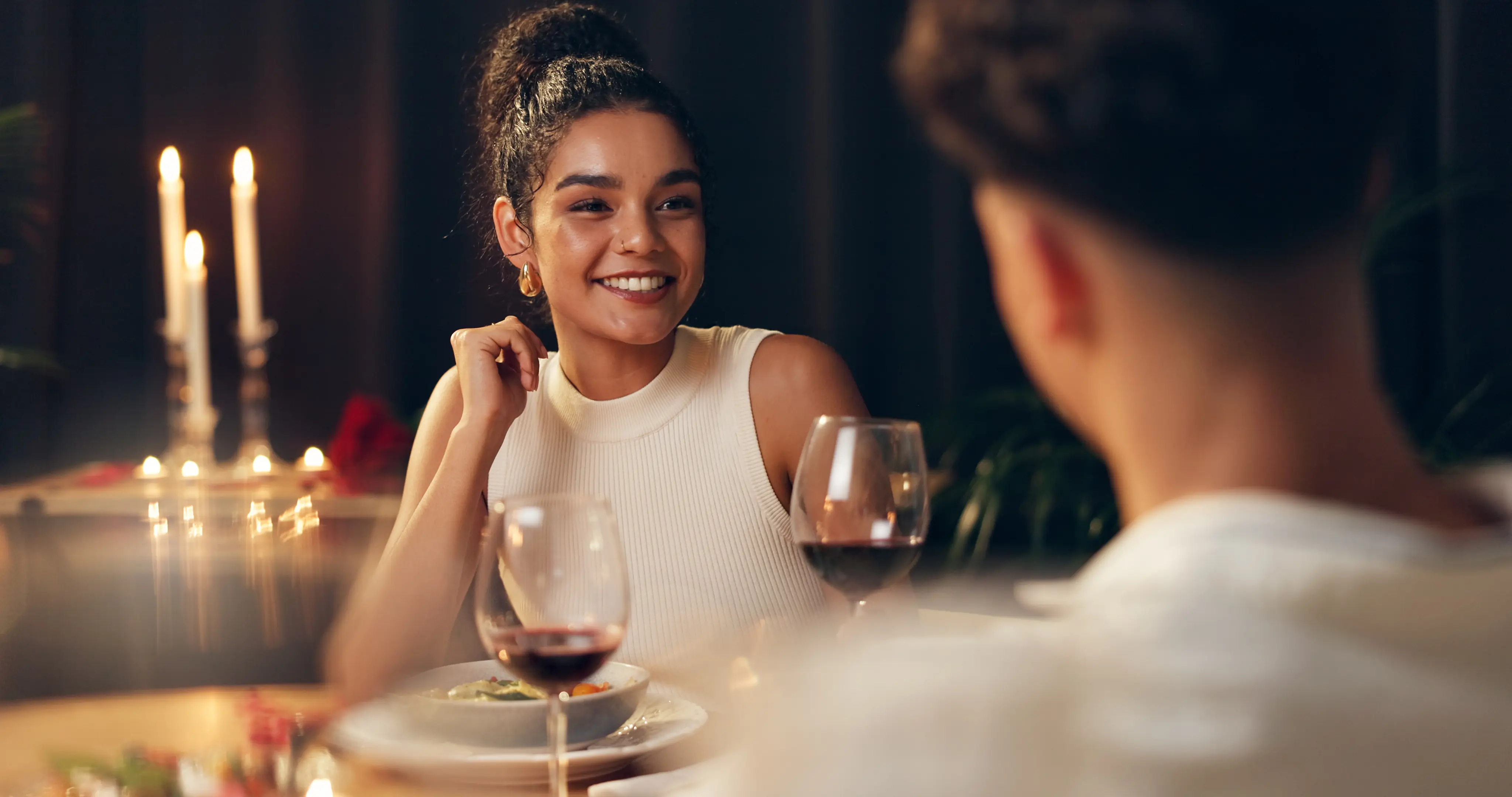 Couple sharing wine and candlelit dinner at a romantic Austin restaurant